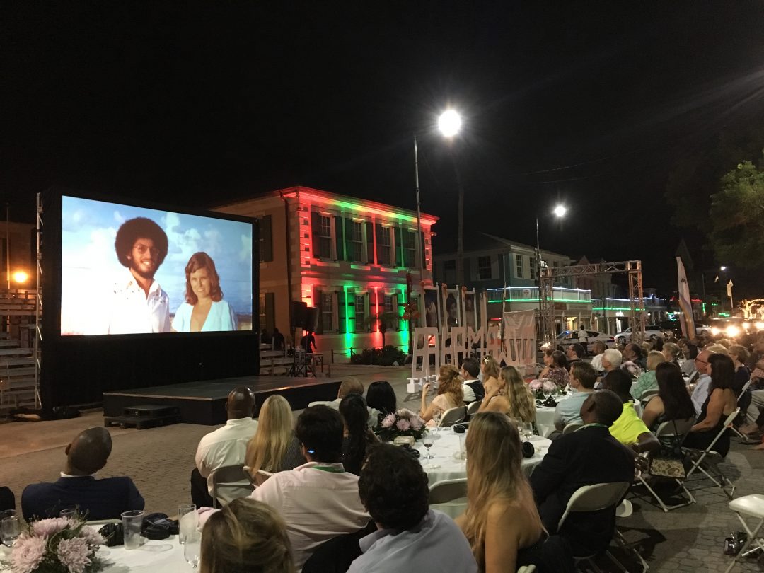 A group of people sitting and watching a screening of the documentary