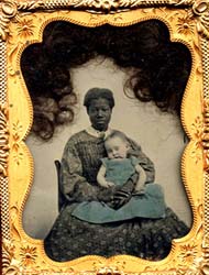 A Black slave woman holding a White child in her lap