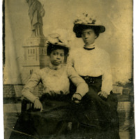 Two women with Statue of Liberty backdrop